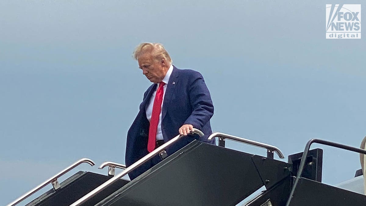 Donald Trump wears suit and red tie