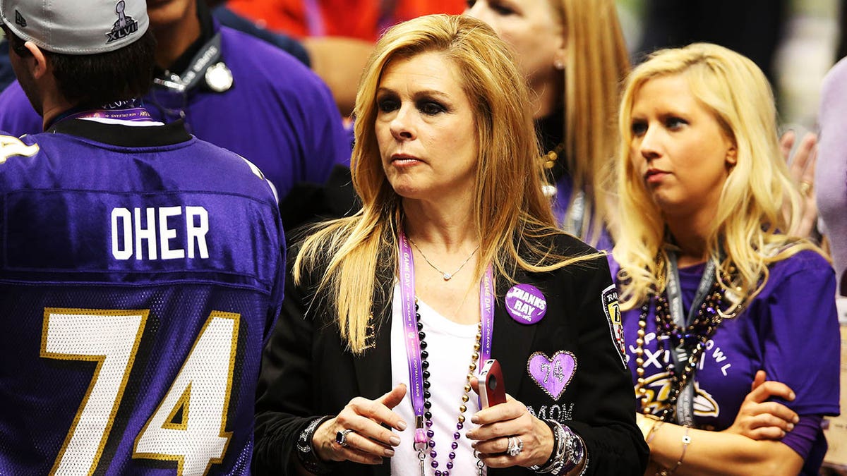 Leigh Anne Tuohy on field at the Super Bowl adorned with purple