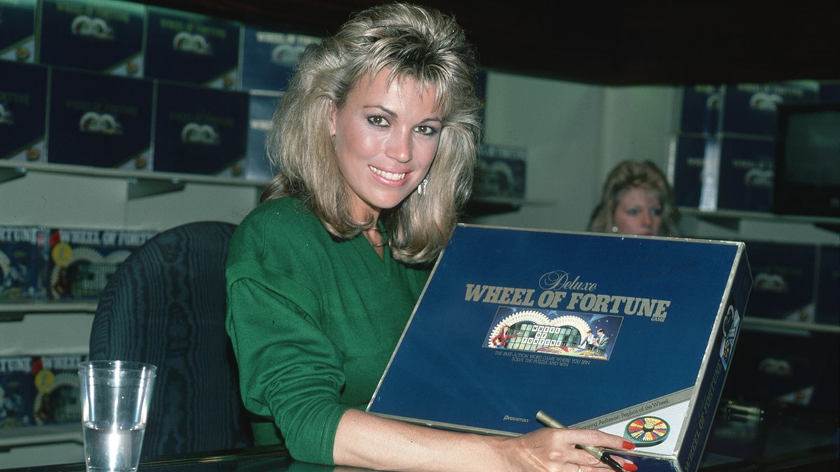 Vanna White signs Wheel of Fortune game