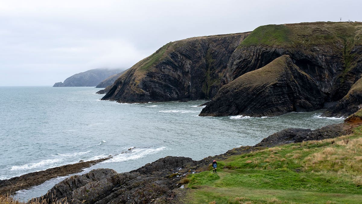 Fog hovers on a coast in Moylgrove, Wales, on July 27, 2023. A car veered off a coastal road after it was speeding downhill in Wales. The vehicle rolled and struck a tent at a campsite.