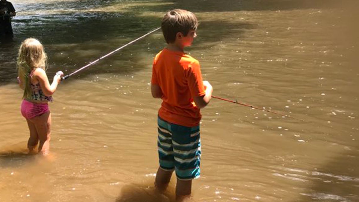 young logan fishing with sister