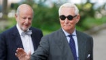 Roger Stone waving as he arrives at U.S. District Court in Washington