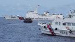 A Philippine supply boat, center, maneuvers around Chinese coast guard ships as they tried to block its way near Second Thomas Shoal, locally known as Ayungin Shoal, at the disputed South China Sea on Aug. 22, 2023.