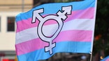 A person holds a transgender pride flag as people gather on Christopher Street outside the Stonewall Inn for a rally to mark the 50th anniversary of the Stonewall Riots in New York, June 28, 2019. - The June 1969 riots, sparked by repeated police raids on the Stonewall Inn -- a well-known gay bar in New Yorks Greenwich Village -- proved to be a turning point in the LGBTQ communitys struggle for civil rights. (Photo by ANGELA WEISS / AFP) (Photo credit should read ANGELA WEISS/AFP via Getty Images)