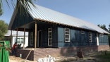The house stands 23 feet above sea level. The house has a chain wall foundation and a metal roof.