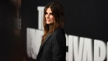 Sandra Bullock looks slightly over her shoulder in a black outfit on the carpet