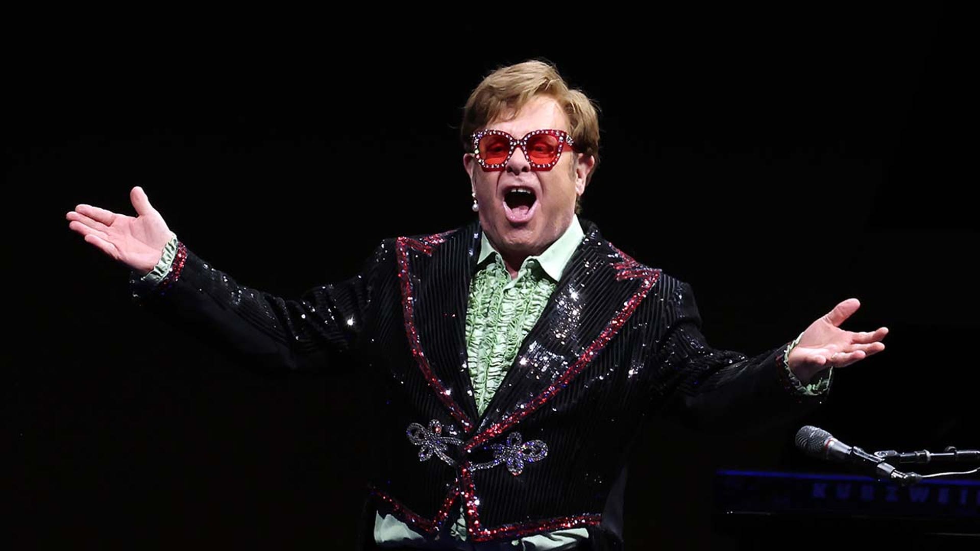 Elton John performs on stage
