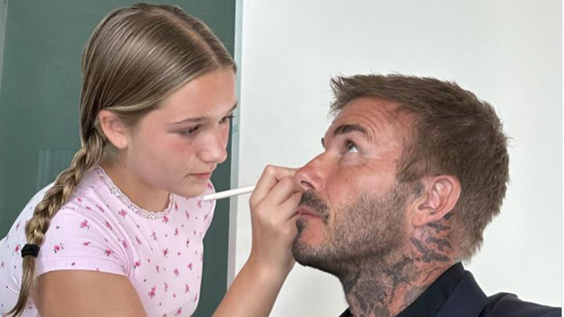 Harper Beckham doing David Beckham's makeup