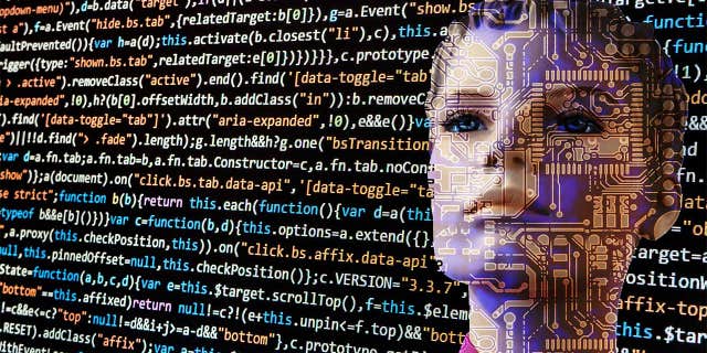 Photo of a bot looking at code.