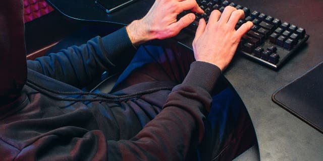 Man typing on his keyboard.