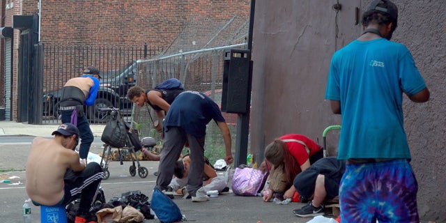 Drug users scatter across Kensington Avenue in Philadelphia's open-air drug market