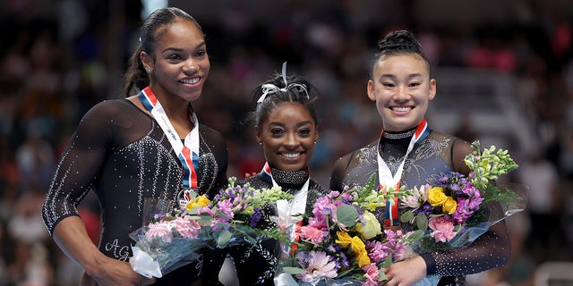 Simone Biles poses with Shi Jones and Leanne Wong