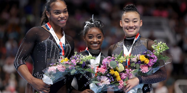 Simone Biles poses with Shi Jones and Leanne Wong