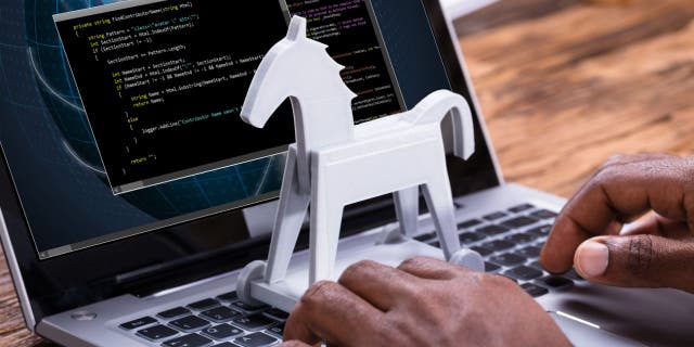 Beware of CherryBlos, the Android malware that steals passwords 4 White mini Trojan horse model placed on the keyboard of a laptop with data on the screen