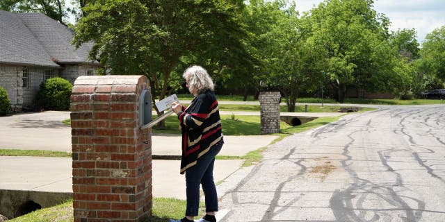 Woman steps out to get her mail