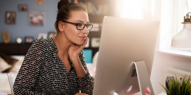 Woman smiling at the computer