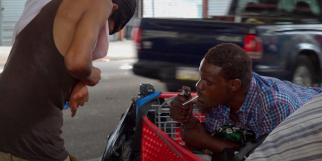 Drug user smoking out of a pipe on Kensington Avenue