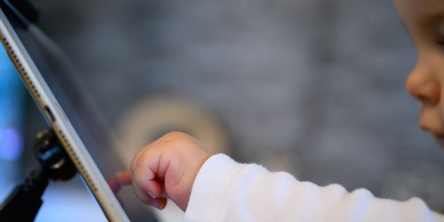 A child operates a tablet