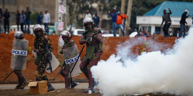 Riot police fire tear gas grenades
