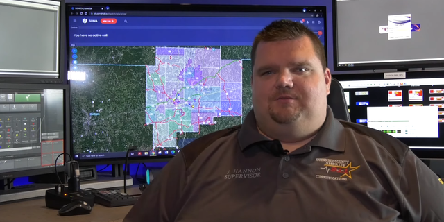 Ohio 911 dispatcher in front of monitor