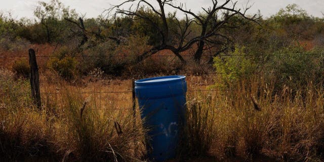 border Texas Mexico water barrel