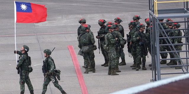 A Taiwanese soldier holding taiwan flag