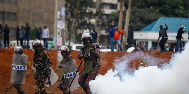  Riot police fire tear gas
