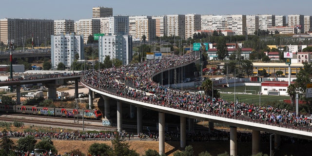 People standing on a bridge