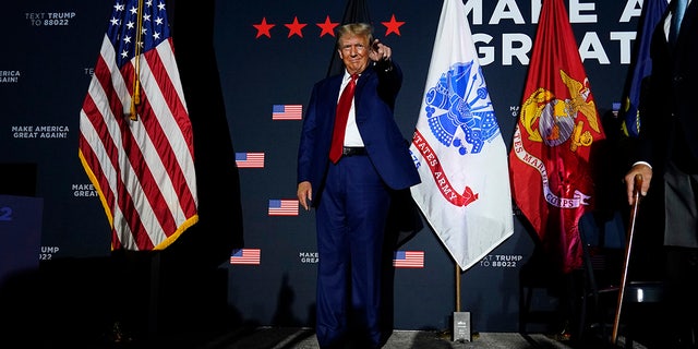 Trump points to a supporter at New Hampshire event