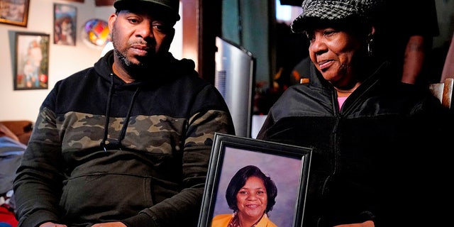 Tops supermarket shooting victim's photo held by family members