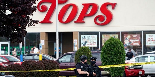 Tops supermarket shooting scene with armed police outside