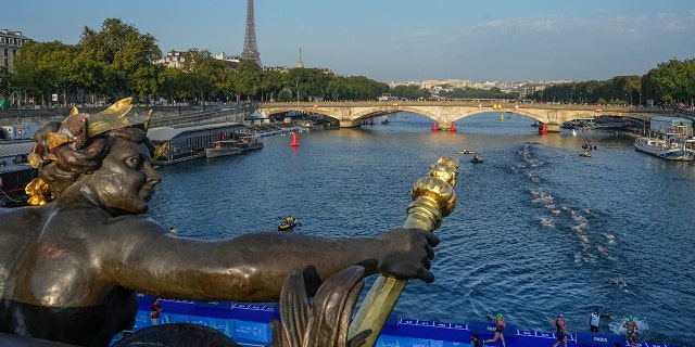 Athletes dive and swim in the Seine river 