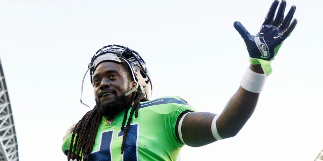 Alex Collins waves