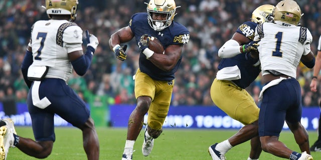 Audric Estime fights between the tackles