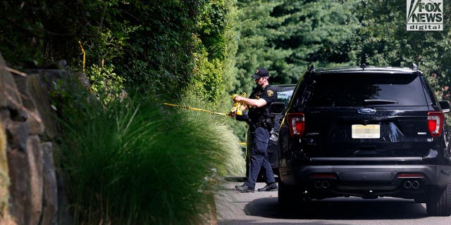 Police cars outside a suburban home