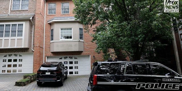 Police cars outside a suburban home