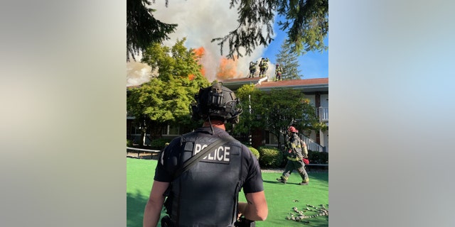 police officer in front of apartment building