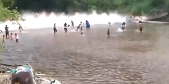 A bridge collapses, splashes in the water with people in Indonesia