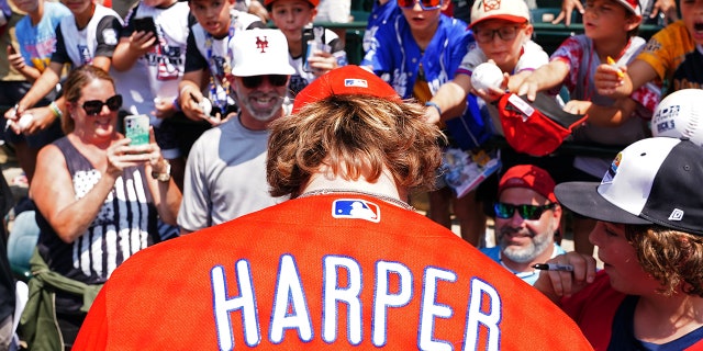 Bryce Harper signs autographs