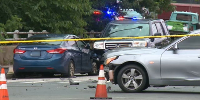 Three cars in a car accident, police tape line do not cross around the scene