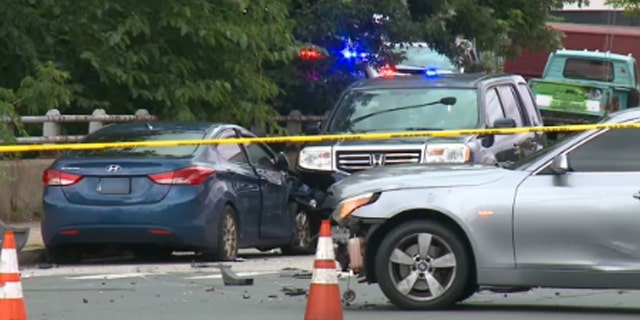 Three cars in a car accident, police tape line do not cross around the scene
