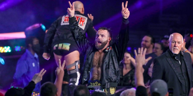 Cash Wheeler goes to the ring during an AEW event