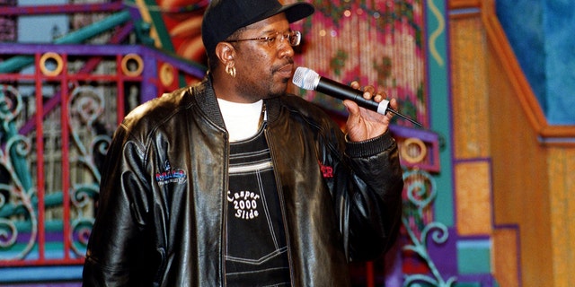 DJ Casper on stage holding a microphone