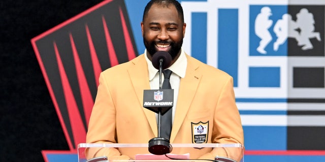 Darrelle Revis smiles at podium