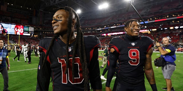 DeAndre Hopkins and Isaiah Simmons walk off field