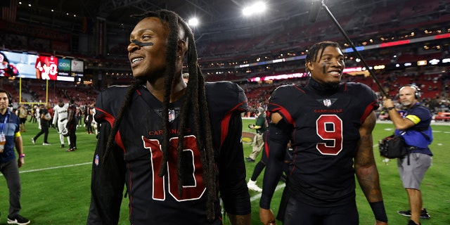 DeAndre Hopkins and Isaiah Simmons walk off field