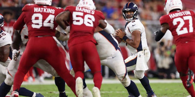 Russell Wilson looks to pass during a preseason game