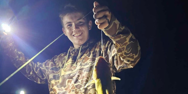 Evan Kinley holds fish