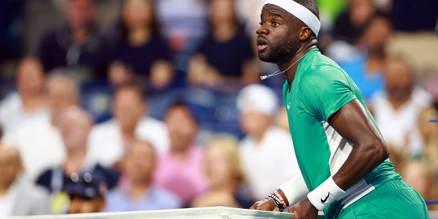 Frances Tiafoe touches net