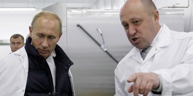 Businessman Yevgeny Prigozhin shows Russian Prime Minister Vladimir Putin